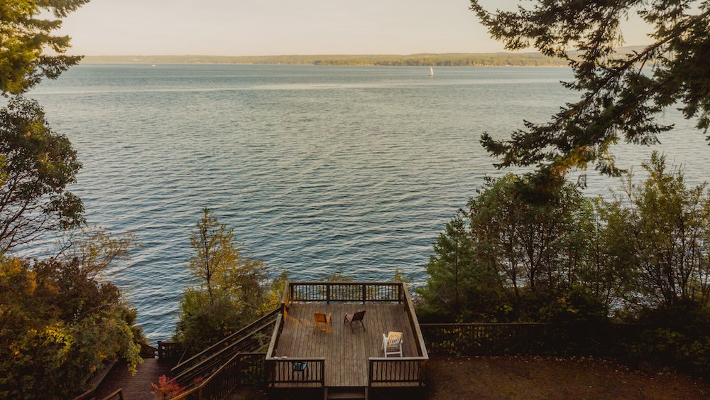 Waterfront home with two chairs on the deck, part of our Olympic National Park Lodging group